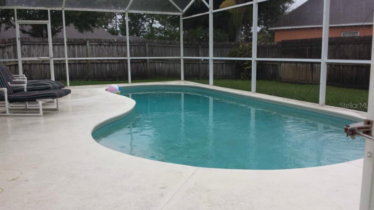 Beautiful pool with a spacious pool deck and it does have a pool screen enclosure.
