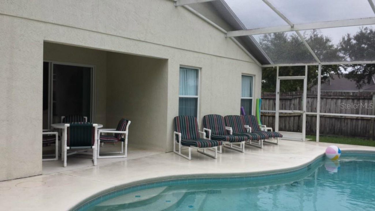 The pool area does offer a covered lanai in the back and plenty of room for entertaining.