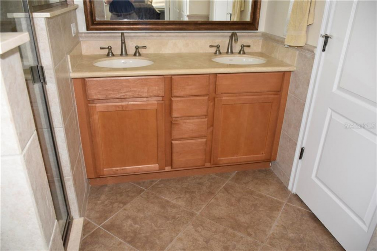 Master bathroom boast with marble countertops and double sinks.