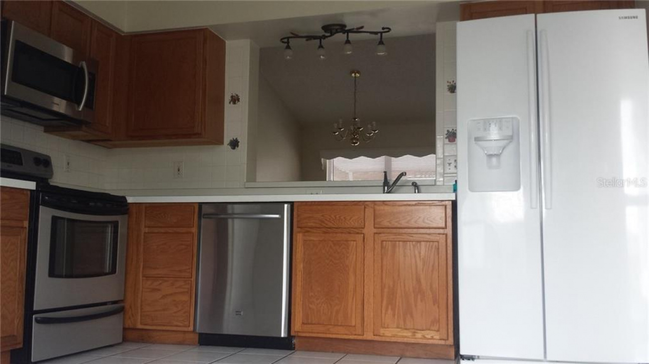 Kitchen provides a stainless steel microwave, range and a dishwasher.